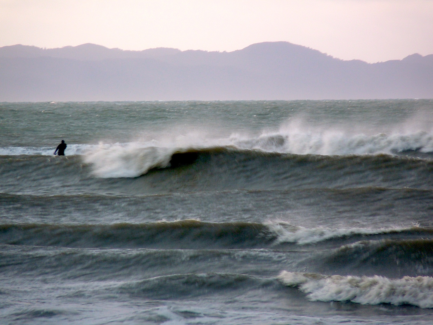 Surfing a SUP in Golden Bay, Patons Rock