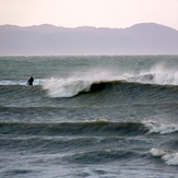 Surfing a SUP in Golden Bay, Patons Rock