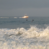 Lifeguard boat and surfers, Gillis