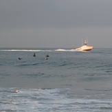 Lifeguard boat and surfers, Gillis