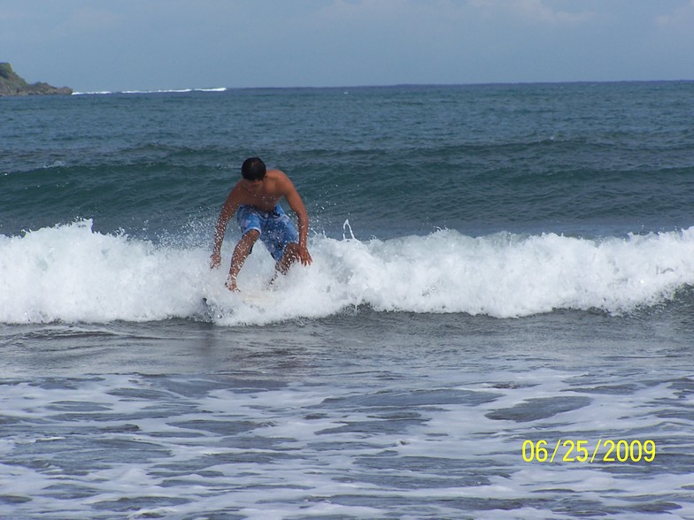 Emman Surfs the waves on Badoc Beach, Badoc Island Lefts