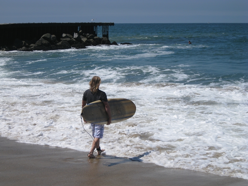 surfer heading into the water, Gillis