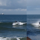 Surfers on each side of groyne (closeup), Gillis
