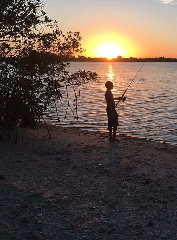 My son fishing at sunset 