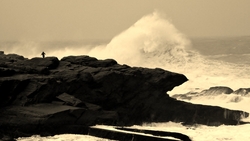 man on rock big swell 2, St Finan's Bay photo