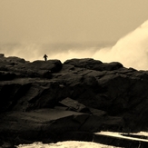 man on rock big swell 2, St Finan's Bay