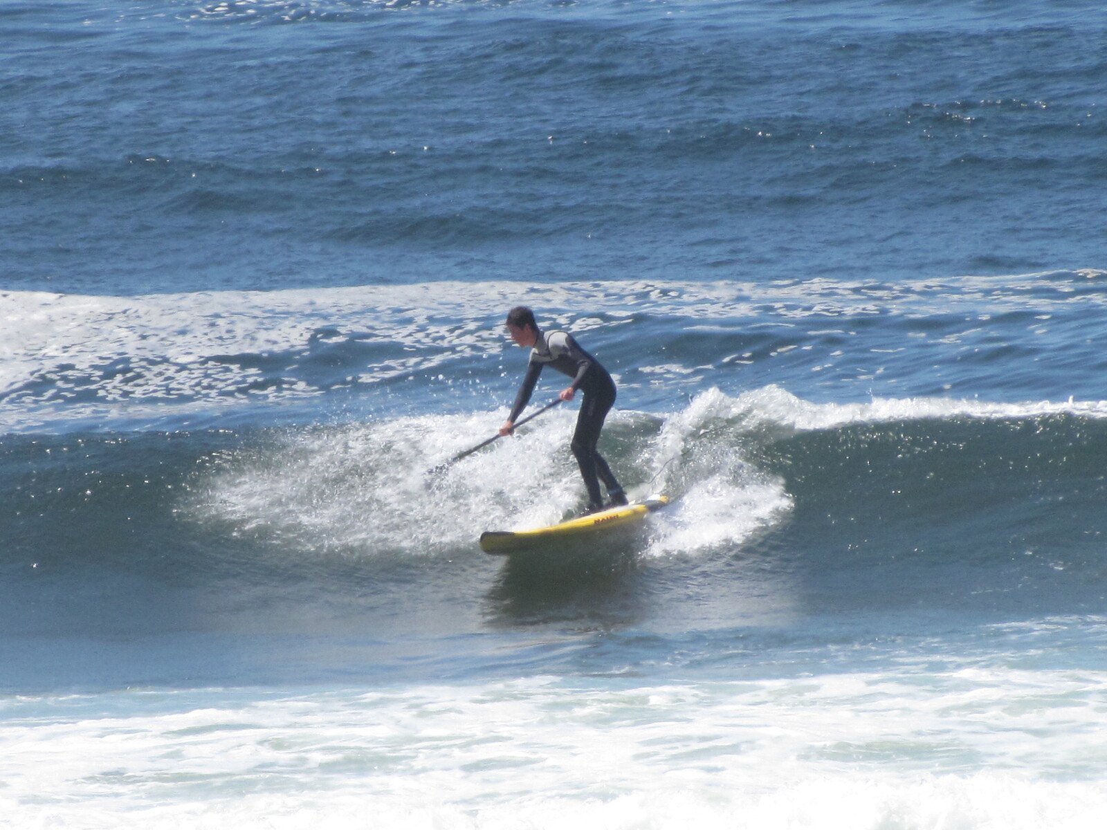 SUP boarder showing how it's done, Pacific City/Cape Kiwanda
