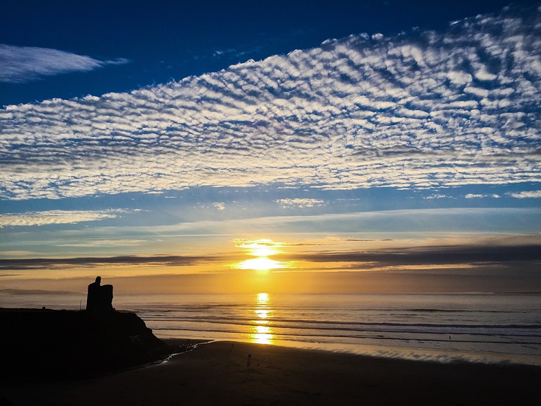 Sunset, high clouds, silhouetted Green Castle, Ballybunion