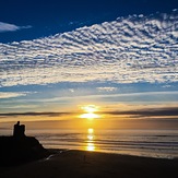 Sunset, high clouds, silhouetted Green Castle, Ballybunion