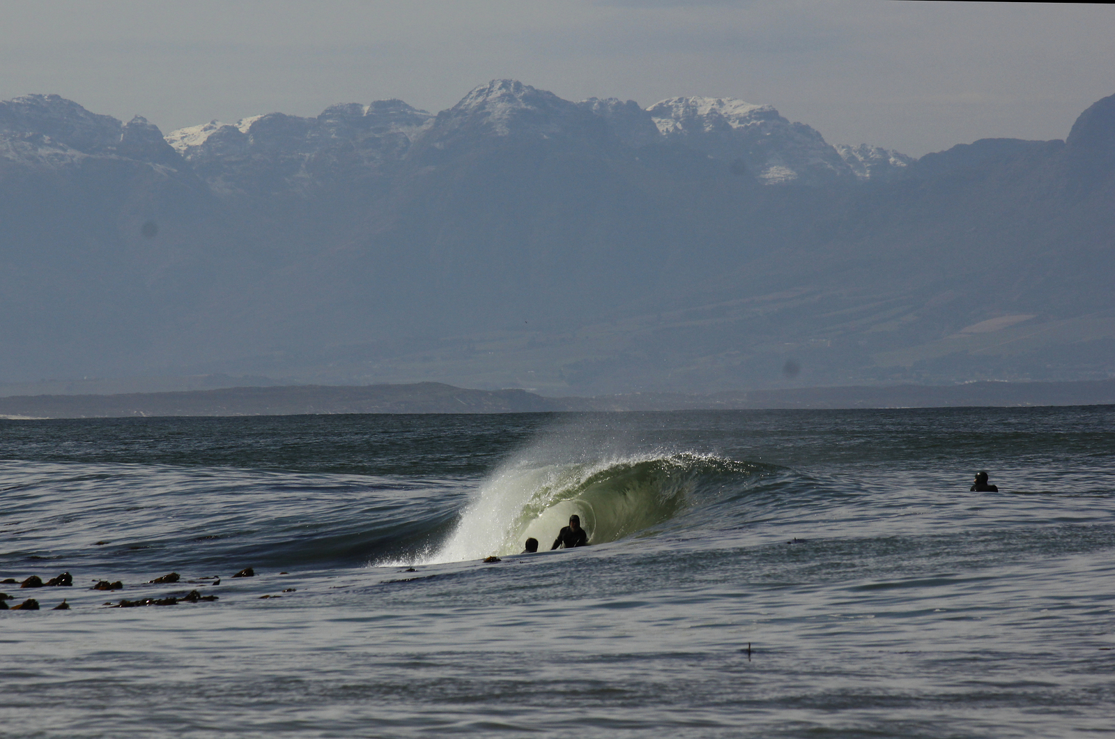 Snow on the mountains and the boys in the water, Kalk Bay Reef