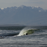 Snow on the mountains and the boys in the water, Kalk Bay Reef