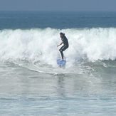 Surfer at jetty next to lifeguard tower 45, Gillis