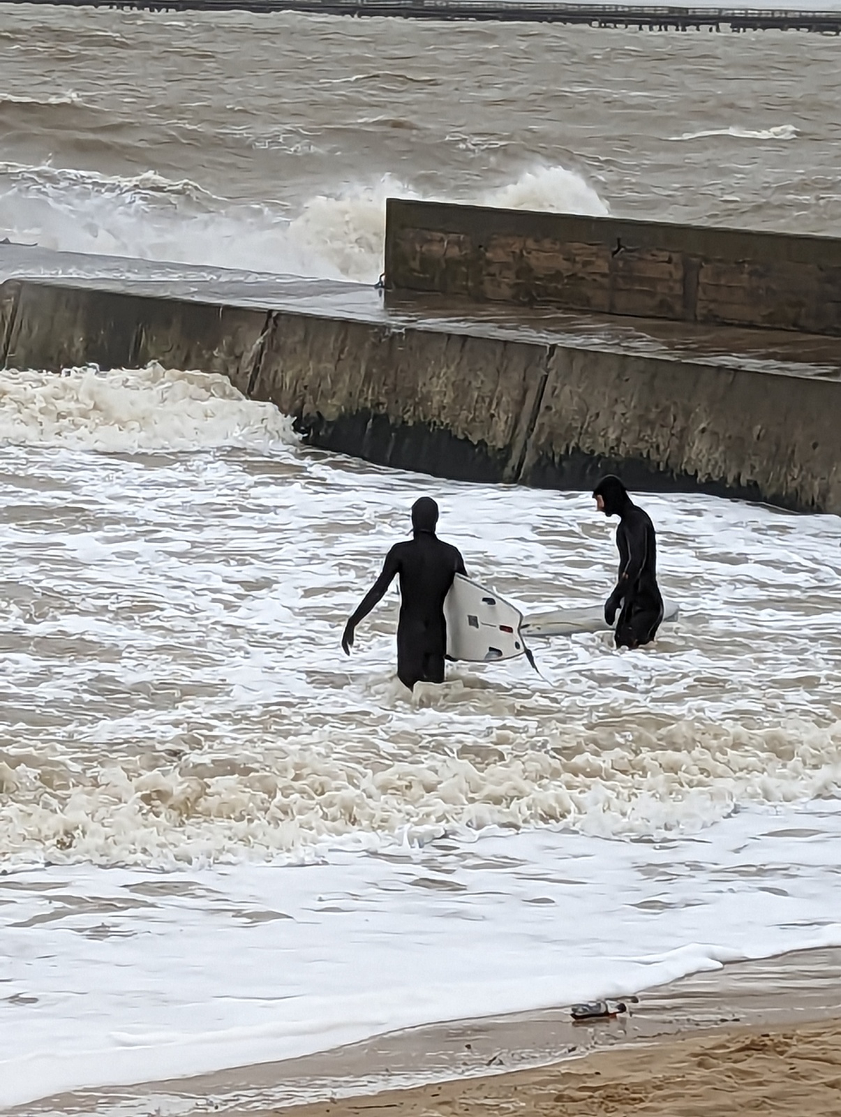 Fred and Seb pause before paddling back out along the jetty, Walton-On-The-Naze