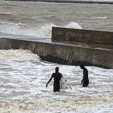 Fred and Seb pause before paddling back out along the jetty, Walton-On-The-Naze