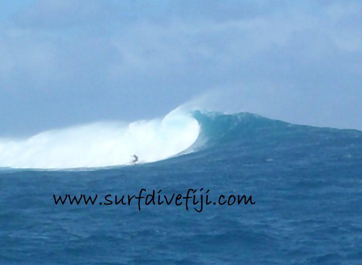 Big wave at Cloudbreak Surfing Fiji