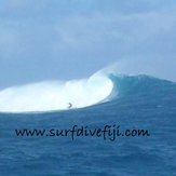 Big wave at Cloudbreak Surfing Fiji