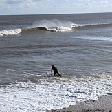 An A-frame cascades onto the sandbanks as the tide drops, Walberswick