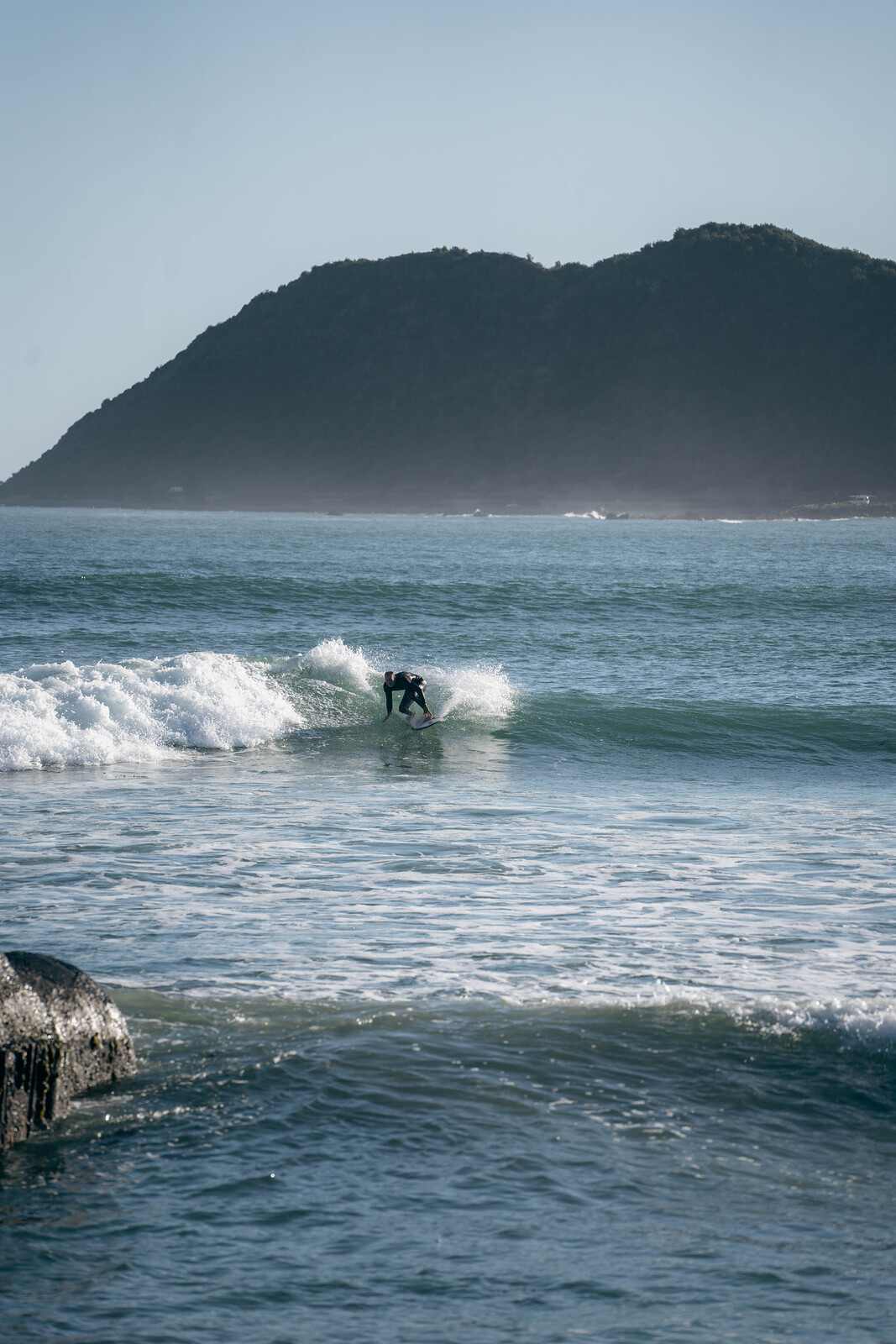 Surfer making the most of a dying wave, Lyall Bay