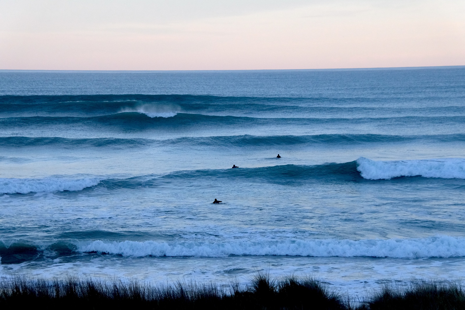 Evening glassy surf at Wainui Beach, Wainui Beach - Whales