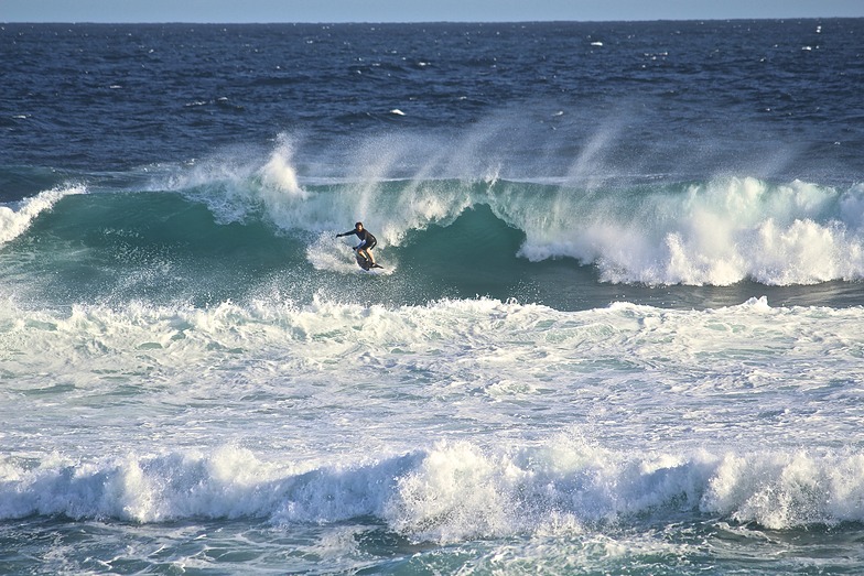 Surfer taking on Soldiers point, Soldiers Beach